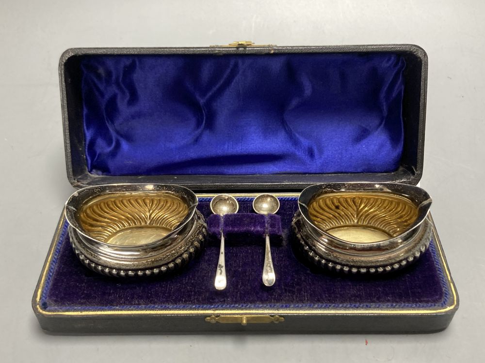 A pair of oval silver salts and spoons (cased), a butter knife and preserve spoon (cased), two pepperettes & a silver cigarette case